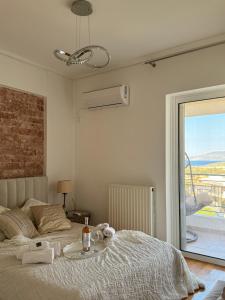 a bedroom with a bed with towels on it at Sea & Mountain Apartment in Lávrion