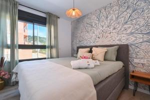 a bedroom with a bed with two stuffed animals on it at Boho chic in Jávea +11 photos