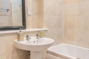 a bathroom with a sink and a bath tub at Contractors & Professionals Look No Further in Leicester