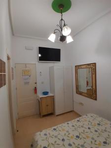 Postel nebo postele na pokoji v ubytování Pensión Antonio Guesthouse
