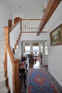 a living room with a staircase and a living room with a rug at Panorama Peak View- Wifi, Screen Porch, Million Dollar View, Fireplace, Full Kitchen in Berkeley Springs