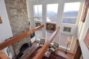 a view of a living room with a stone fireplace at Panorama Peak View- Wifi, Screen Porch, Million Dollar View, Fireplace, Full Kitchen in Berkeley Springs