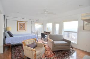 a bedroom with a bed and a chair and a desk at Panorama Peak View- Wifi, Screen Porch, Million Dollar View, Fireplace, Full Kitchen in Berkeley Springs