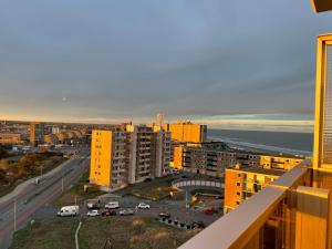 a view of a city with buildings and the ocean at apartment with sea view in Zandvoort