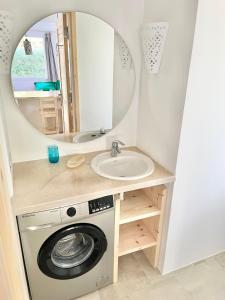 a bathroom with a washing machine and a sink at Lagoon Apartment in Dahab