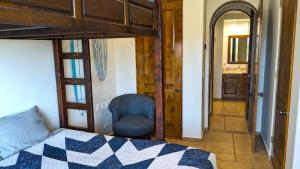a bedroom with a bed and a chair in a room at Bella Sirena 304-A - Elegant Oceanview Condo on Sandy Beach in Puerto Peñasco +36 photos