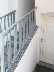 un escalier avec une balustrade bleue à côté d'une porte dans l'établissement Green Home - Bellagio Apt, à Côme