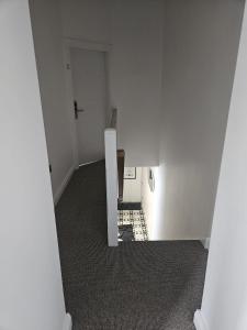 an empty white room with a staircase and a stair case at Number33 in Galway