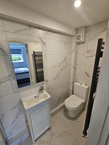 a white bathroom with a sink and a toilet at Number33 in Galway