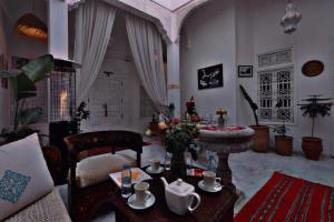 a living room with a couch and a table at Riad Morocco Sky in Marrakech