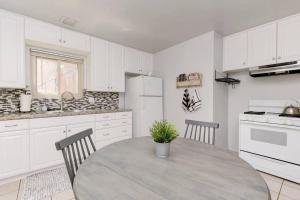 a white kitchen with a table and chairs in it at Casa Amore -2BR- FREE Driveway parking for 3 cars in San Diego +10 photos