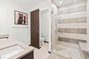 a bathroom with a shower and a sink and a toilet at 38359 Hwy 6 #14C - Basecamp in Avon +36 photos