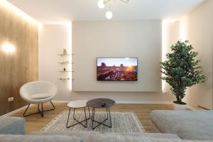 a living room with a couch and a christmas tree at Grandstay Apartments in Durrës