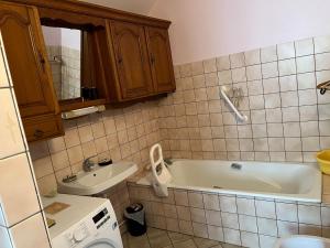 a bathroom with a bath tub and a sink at Gite le Saint André in Villers-sur-Port