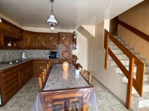 a kitchen with a table and chairs and a staircase at Gite le Saint André in Villers-sur-Port