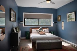 a blue bedroom with a bed and a window at Retreat 34A in Daylesford