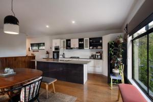 a kitchen and living room with a table and a counter at Retreat 34A in Daylesford