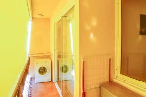 a laundry room with a washing machine in a hallway at Equipped Centric Apartment with large terrace in Lloret de Mar