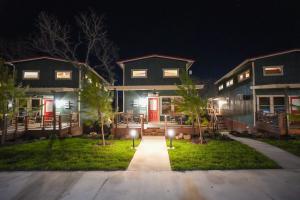 a house with red doors at night at CampQYB- Modern Lux Cabin Hot Tub FirePit Games in Runaway Bay
