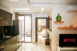 a kitchen with a view of a living room at Résidence Sheren - Maarif in Casablanca