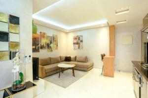 a living room with a couch and a table at Résidence Sheren - Maarif in Casablanca