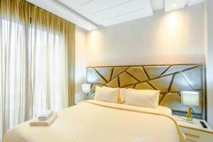 a hotel room with a large bed and a window at Résidence Sheren - Maarif in Casablanca