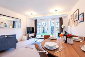 a living room with a wooden table and a dining room at Ambassador House by Truestays - Luxury 4 Bedroom House in Stoke-on-Trent in Etruria