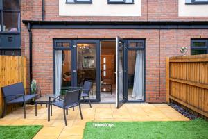 a patio with glass doors on a brick building at Ambassador House by Truestays - Luxury 4 Bedroom House in Stoke-on-Trent in Etruria