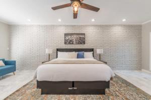 a bedroom with a large bed and a ceiling fan at Mansion With Private Pool Basketball & Tennis courts in Fayetteville