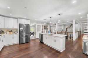 a kitchen with white cabinets and stainless steel appliances at Mansion With Private Pool Basketball & Tennis courts in Fayetteville