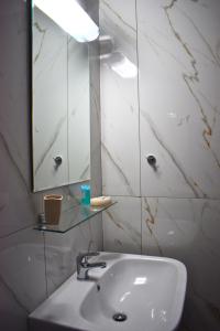 a bathroom with a sink and a mirror at Venice Apartments in Limenaria