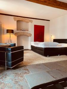 a bedroom with a bed and a fire place at Klosterhof Weingut BoudierKoeller in Stetten