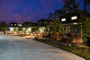 a row of houses at night at CampQYB- Modern Lux Cabin Hot Tub FirePit Sauna in Runaway Bay