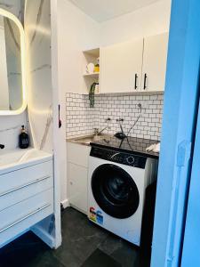 a washing machine in a kitchen with a sink at Stylish tiny home in Melton west in Melton