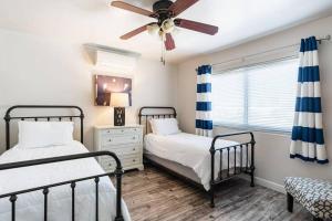 a bedroom with two beds and a ceiling fan at Casa Italia -2BR- FREE Driveway parking for 2 cars in San Diego