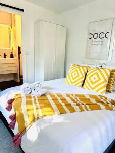 a bedroom with a bed with towels on it at Stylish tiny home in Melton west in Melton