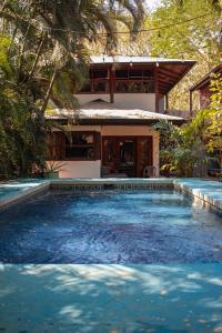 a swimming pool in front of a house at Chocolate in Tamarindo +16 photos