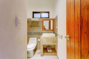 a bathroom with a toilet and a sink at Stay in the Heart of Tulum l best location in Town in Tulum