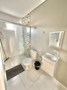 a bathroom with a shower and a toilet and a sink at Hotel Manaus - Dom Pedro I in Manaus