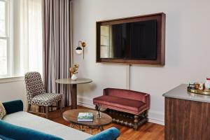 ein Wohnzimmer mit einem Sofa und einem TV in der Unterkunft Hotel Granada in Atlanta