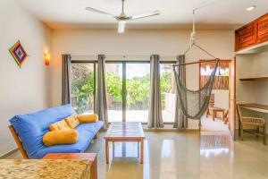a living room with a blue couch and a table at Stay in the Heart of Tulum l best location in Town in Tulum