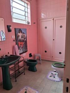 a pink bathroom with a sink and a toilet at Casa Térrea SP Expo e C Paralimpico in São Paulo