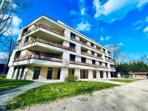 a large white building with a lot of windows at Beach Home Apartman in Balatonfüred