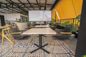 a conference room with a table and chairs and a screen at EXCLUSIVO LOFT. CAOBOS COLIVING&COWORKING. ZONA T in Cúcuta