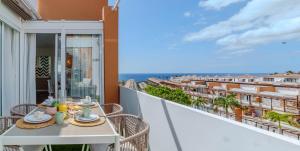 a balcony with a table and a view of the ocean at CASA TITINA in San Miguel de Abona