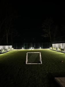 um campo de futebol à noite com um golo em Oaza Mira Laze - Luxury Private Villa with Pool, Football Field em Nova Gradiska