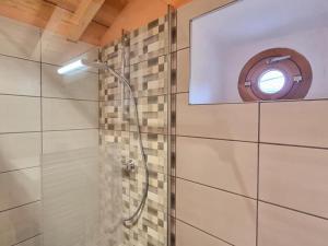 a bathroom with a shower with a window at Gîte Verrières-en-Forez, 4 pièces, 10 personnes - FR-1-496-314 in Verrières-en-Forez