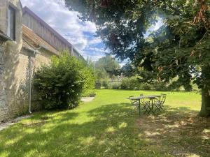 ComblotLongère Percheronne avec jardin clos et cheminée luxueuse - FR-1-497-197的树旁院子内的野餐桌