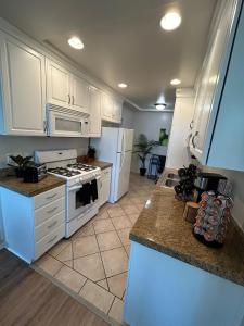 a kitchen with white cabinets and a white stove top oven at Beverly Hills Midle City 1 br Apt with Parking 202 in Los Angeles