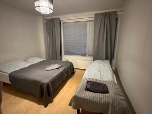 a bedroom with two beds and a window at Berlin 2BR home in heard of Tornio in Tornio